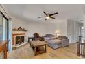 Inviting living room with a cozy fireplace, hardwood flooring, and bright natural light at 702 Hanover Se Ln, Marietta, GA 30067