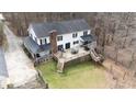 Aerial view of backyard with a spacious deck, outdoor furniture, and a lush lawn at 1700 Bailey Creek Sw Rd, Conyers, GA 30094