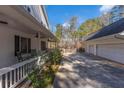 Charming home featuring a long driveway leading to a detached garage and a cozy front porch with rocking chairs at 1700 Bailey Creek Sw Rd, Conyers, GA 30094