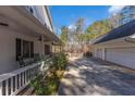 Long driveway with a detached two-car garage and a covered porch with rocking chairs at 1700 Bailey Creek Sw Rd, Conyers, GA 30094