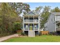 Attractive two-story home featuring a blue facade, double porches, and a bright yellow front door at 1183 Mobile Nw St, Atlanta, GA 30314