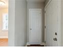 Neutral entryway featuring two white doors, neutral walls and hardwood floors at 1850 Brewer Sw Blvd, Atlanta, GA 30310