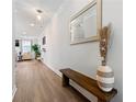 Inviting hallway with wood floors, large mirror, bench, and view into the living area at 3610 Silvery Way, Powder Springs, GA 30127