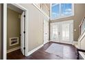 Bright foyer featuring wood floors, a staircase, and a large window above the front doors at 1034 Fairview Club Cir, Dacula, GA 30019