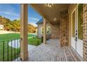 Inviting covered front porch with brick flooring, stone accents, and a view of the landscaped front yard at 5887 Thistle Ct, Douglasville, GA 30135