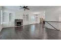 Spacious living room with hardwood floors, fireplace, and custom built-in shelving at 110 Rose Garden Ln, Alpharetta, GA 30009