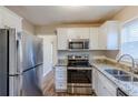 Well-equipped kitchen with stainless steel refrigerator, microwave, and granite countertops at 2080 Dellwood Pl, Decatur, GA 30032