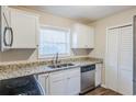 Bright kitchen featuring white cabinets, granite countertops, and stainless steel appliances at 2080 Dellwood Pl, Decatur, GA 30032