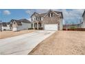 Two-story brick home with attached two car garage, black shutters and covered front porch at 7890 Bristol Valley Dr, Cumming, GA 30028