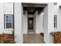 Close up of the front door featuring decorative glass and a black frame surrounded by white painted brick columns at 2890 Longbush Lane, Duluth, GA 30097