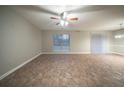 Spacious living room featuring modern tile floors, a ceiling fan, and a large window that offers plenty of natural light at 5087 Donnell Way, Decatur, GA 30035