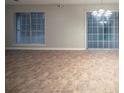 Bright living room with tile floors, a window and sliding glass doors for natural light, and neutral-colored walls at 5087 Donnell Way, Decatur, GA 30035