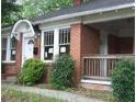 Charming brick home featuring a covered porch and detailed window trim at 837 Metropolitan Pkwy, Atlanta, GA 30310