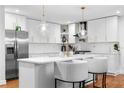 Modern kitchen with stainless steel appliances, white cabinetry, and pendant lighting at 770 Waters Sw Dr, Atlanta, GA 30310