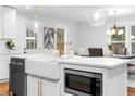 Bright kitchen with large island, farmhouse sink, and stainless steel microwave at 770 Waters Sw Dr, Atlanta, GA 30310