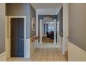 Elegant hallway with tiled floor, decorative columns and wainscotting leads into the living spaces at 832 Chalet Hls, Mcdonough, GA 30253