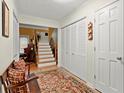 Inviting entryway with a staircase, coat closet, and bench with colorful rug at 1745 Pierce Arrow Pkwy, Tucker, GA 30084