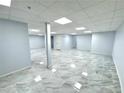 Finished basement area featuring sleek gray floors, perfect for creating additional living space at 6553 Meadowbrook Ln, Morrow, GA 30260