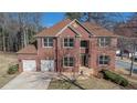 Charming two-story brick home with a two car garage and a well maintained front yard at 10950 Glenhurst Pass, Duluth, GA 30097