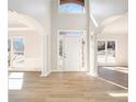 Bright foyer with grand arches, white columns and trim, and light wood floors at 10950 Glenhurst Pass, Duluth, GA 30097