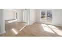 Inviting living room featuring bright white trim and light wood flooring at 10950 Glenhurst Pass, Duluth, GA 30097