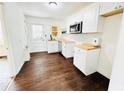 Cozy kitchen with white cabinets, wood countertops, stainless steel appliances, and subway tile backsplash at 4206 Sherwood Ave, Decatur, GA 30035