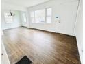 Inviting living room with hardwood floors, a front door, and large windows providing ample light at 4206 Sherwood Ave, Decatur, GA 30035