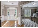 Welcoming foyer with hardwood floors, white trim, and a view into an office through glass French doors at 4580 Windsor Park Place, Atlanta, GA 30342