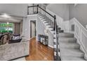 Elegant staircase with carpeted steps, white railing, and black accents, leading to the upper level at 4580 Windsor Park Place, Atlanta, GA 30342