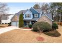 Beautiful two-story home featuring a well-kept lawn, mature trees, and a two-car garage at 923 Buckhorn Bnd, Locust Grove, GA 30248