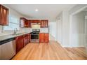 Bright kitchen features wooden floors, stainless steel appliances, and granite countertops at 1838 Nicole Ln, Lithonia, GA 30058