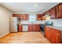 Well-lit kitchen features stainless steel appliances, granite countertops, and wooden floors at 1838 Nicole Ln, Lithonia, GA 30058