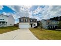 A two story home with neutral paint, dark shutters, and a two car garage at 720 Dove Tree Ln, Social Circle, GA 30025