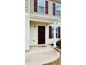 Front door is a dark wood with a covered stoop and siding at 720 Dove Tree Ln, Social Circle, GA 30025