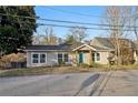 Exterior shot of a charming home featuring a bright blue front door and tidy landscaping at 1268 Wylie Se St, Atlanta, GA 30317