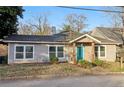 Charming house featuring a bright blue front door and tidy landscaping at 1268 Wylie Se St, Atlanta, GA 30317