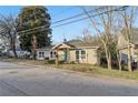 Charming house with a bright blue front door, tidy landscaping, and many trees at 1268 Wylie Se St, Atlanta, GA 30317