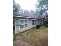 Side view of the home, showcasing the gray siding, double-pane windows, and well-manicured lawn at 1268 Wylie Se St, Atlanta, GA 30317