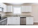 Close-up of kitchen cabinets, stainless steel appliances, and granite counters at 6297 Temple St, Lithia Springs, GA 30122