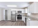 Well-lit kitchen with white cabinets and modern stainless steel appliances at 6297 Temple St, Lithia Springs, GA 30122