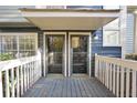 Charming front porch with double doors, painted blue floor and white railings at 1482 N Crossing Ne Cir, Atlanta, GA 30329