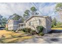 Well-maintained gray home with a sidewalk and manicured hedges on a sunny day at 4124 Casa Loma Dr, Decatur, GA 30034