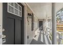 Covered front porch with white columns, dark door, and exterior lighting at 4124 Casa Loma Dr, Decatur, GA 30034