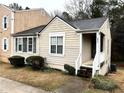 Quaint single-story home with a welcoming front porch and small shrubs at 6473 Bedford Ln, Lithonia, GA 30058