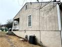 Exterior side view shows AC unit and gas meter on the side of the home at 6473 Bedford Ln, Lithonia, GA 30058