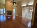 Spacious living room with a stone fireplace, hardwood floors and archways at 2110 Retreat Haven Ln, Dacula, GA 30019