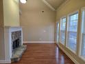 Living room with a stone fireplace, hardwood floors and natural light at 2110 Retreat Haven Ln, Dacula, GA 30019