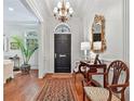 Elegant foyer boasting a striking black door, chandelier, hardwood floors, and a decorative mirror at 3131 Nw Slaton Nw Dr # 24, Atlanta, GA 30305