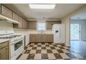Bright kitchen with updated countertops, checkerboard floors, and stainless-steel appliances at 821 Stonebridge Park Cir, Lithonia, GA 30058
