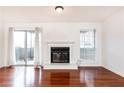 Hardwood floored living room with fireplace and sliding doors to outdoor balcony at 2901 Lenox Ne Way # 902, Atlanta, GA 30324